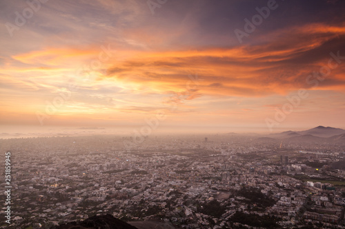 View of the large city Lima (Peru) from the first hills of the Andes, situated between Surco and La Molina, at sunset.