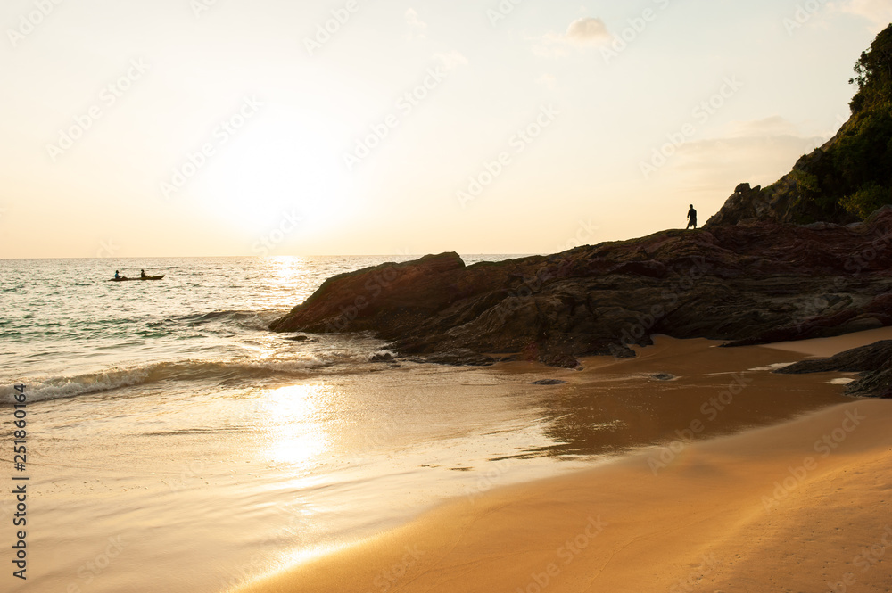 Kayaking and fishing by the sunset sea.