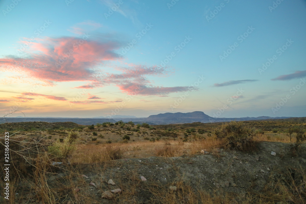 beautiful sunset in the prairie with mountain background