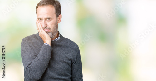 Handsome middle age senior man wearing a sweater over isolated background thinking looking tired and bored with depression problems with crossed arms.