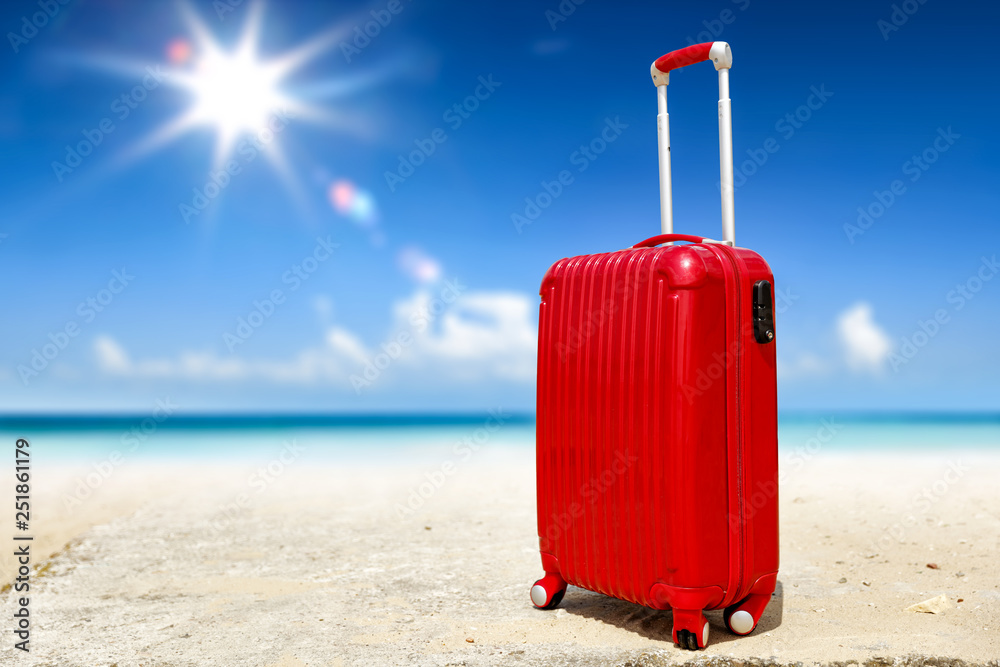 Summer suitcase on beach and sea landscape Summer suitcase on beach and sea landscape