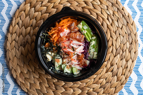 hawaii poke bowl with salmon  rice  surimi  avocado  tobiko  carrot and seaweed