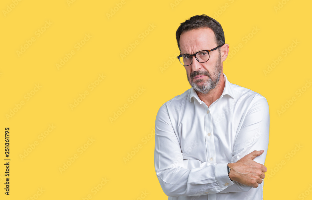 Handsome middle age elegant senior business man wearing glasses over isolated background skeptic and nervous, disapproving expression on face with crossed arms. Negative person. Handsome middle age elegant senior business man wearing glasses over isolated background skeptic and nervous, disapproving expression on face with crossed arms. Negative person.