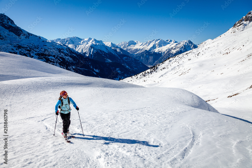 A young woman is going for some ski touring in the backcountry.