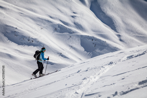 A young woman is going for some ski touring in the backcountry.