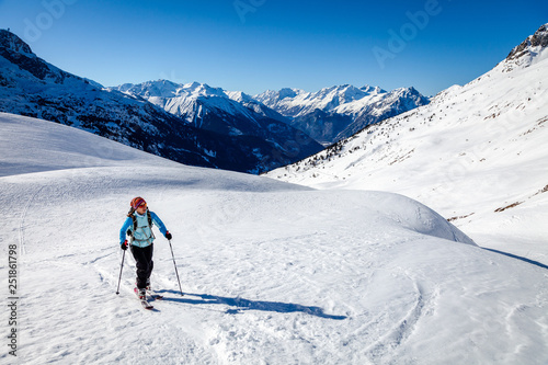 A young woman is going for some ski touring in the backcountry.