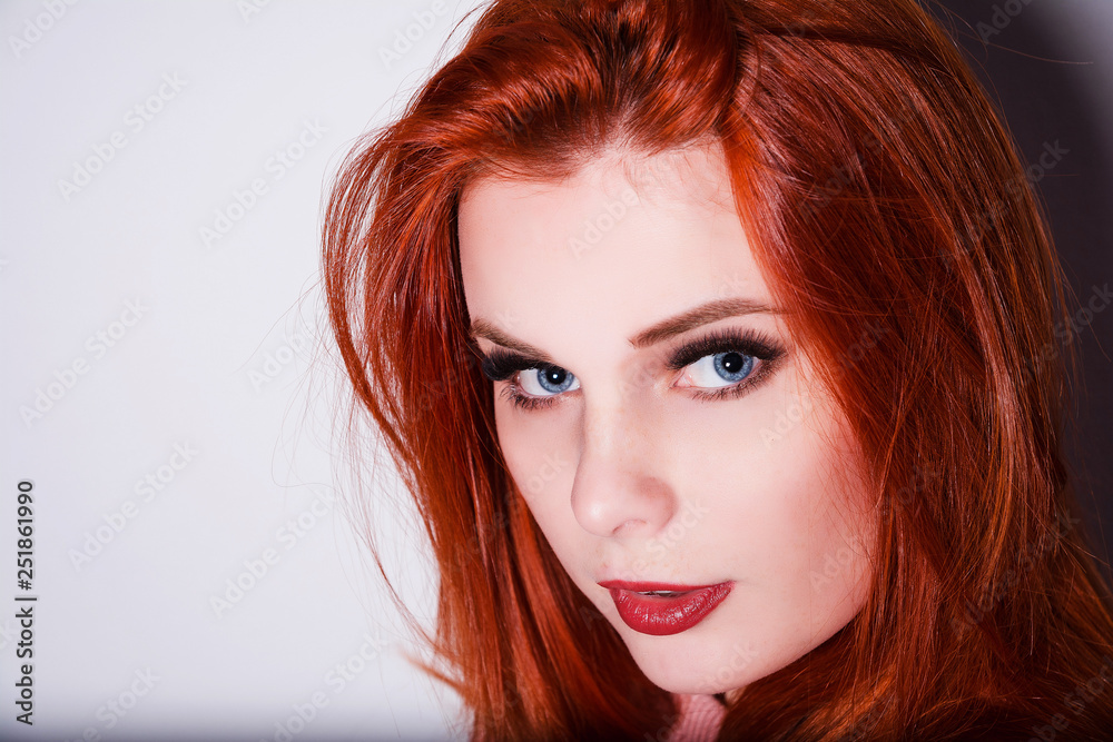 portrait of red-haired girl at the white wall portrait of red-haired girl at the white wall