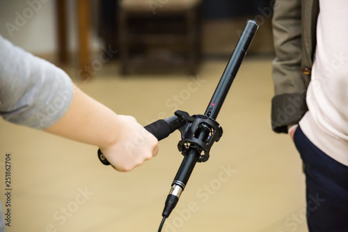 Condenser Shotgun Microphone. A woman interviews a man. The microphone in the reporter s hand.