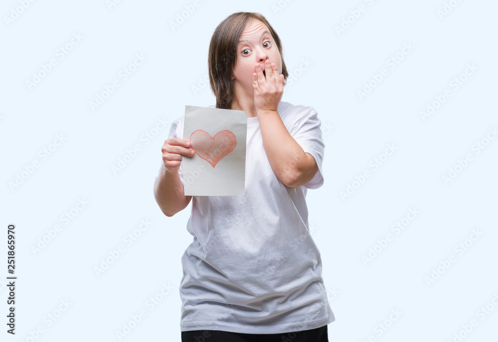 Young adult woman with down syndrome holding red heart card over isolated background cover mouth with hand shocked with shame for mistake, expression of fear, scared in silence, secret concept Young adult woman with down syndrome holding red heart card over isolated background cover mouth with hand shocked with shame for mistake, expression of fear, scared in silence, secret concept