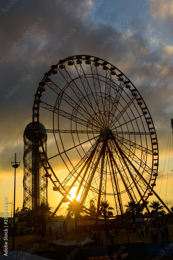 Ferris wheel on amazing sunset sky background