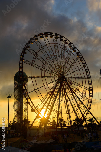 Ferris wheel on amazing sunset sky background