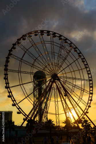 Ferris wheel on amazing sunset sky background