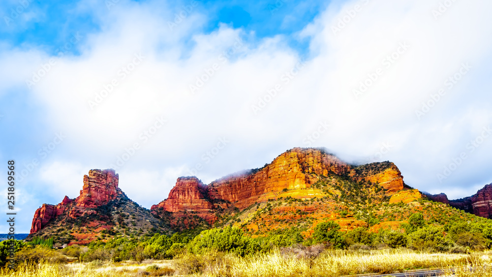 Clouds hanging over the colorful sandstone mountains at the northern edge of the Village of Oak Creek in northern Arizona, in Coconino National Forest, USA