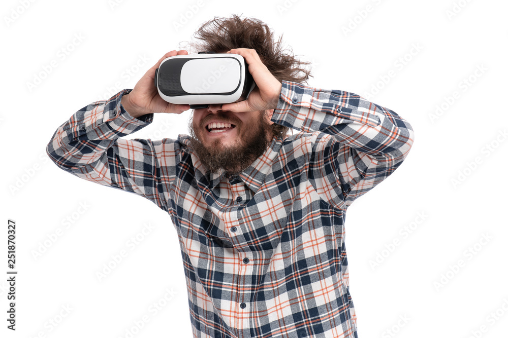 Crazy bearded Man in plaid shirt with funny Haircut wearing virtual reality helmet, isolated on white background. Portrait of funny man using VR goggles. Crazy bearded Man in plaid shirt with funny Haircut wearing virtual reality helmet, isolated on white background. Portrait of funny man using VR goggles.