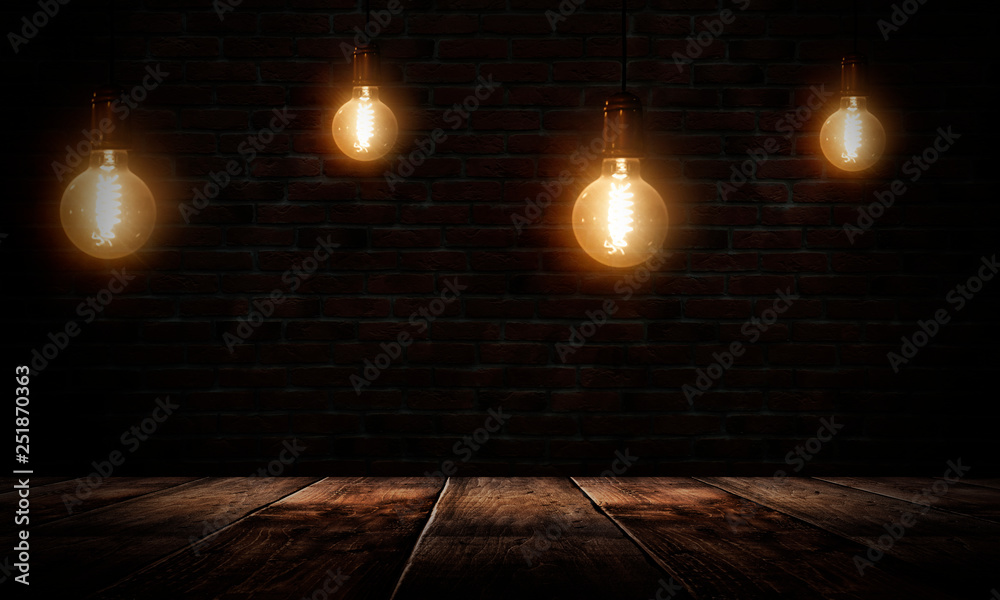 Dark empty room, wooden table, brick walls, lamps. Night view. Dark empty room, wooden table, brick walls, lamps. Night view.