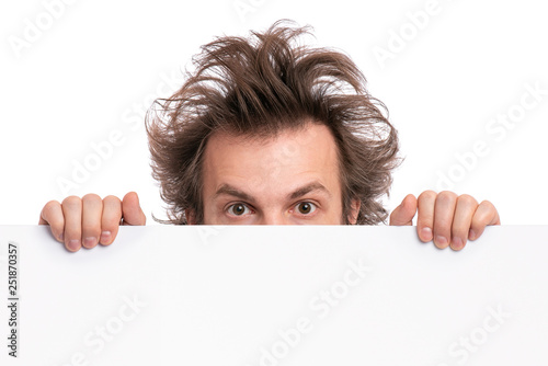 Billede på lærred Crazy bearded Man with funny Haircut showing empty blank signboard with copy space
