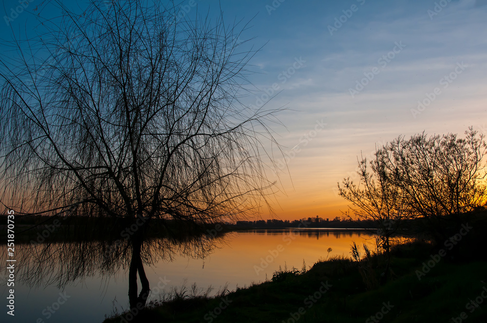 Sunset over the river and trees