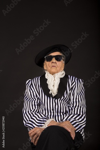 Old grandma in a white-black striped jacket