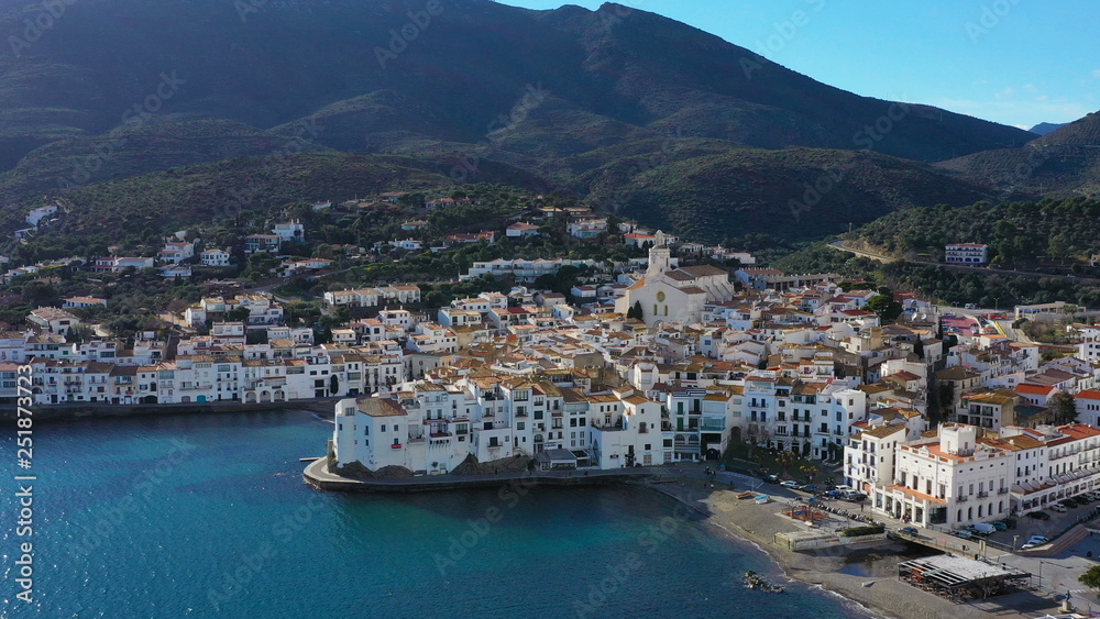 Adoarble Cadaques Spain. cozy beautiful houses streets and tiled roofs. Aerial drone video footage of the camera approaches the city. sunny daylight. Mountains and the city