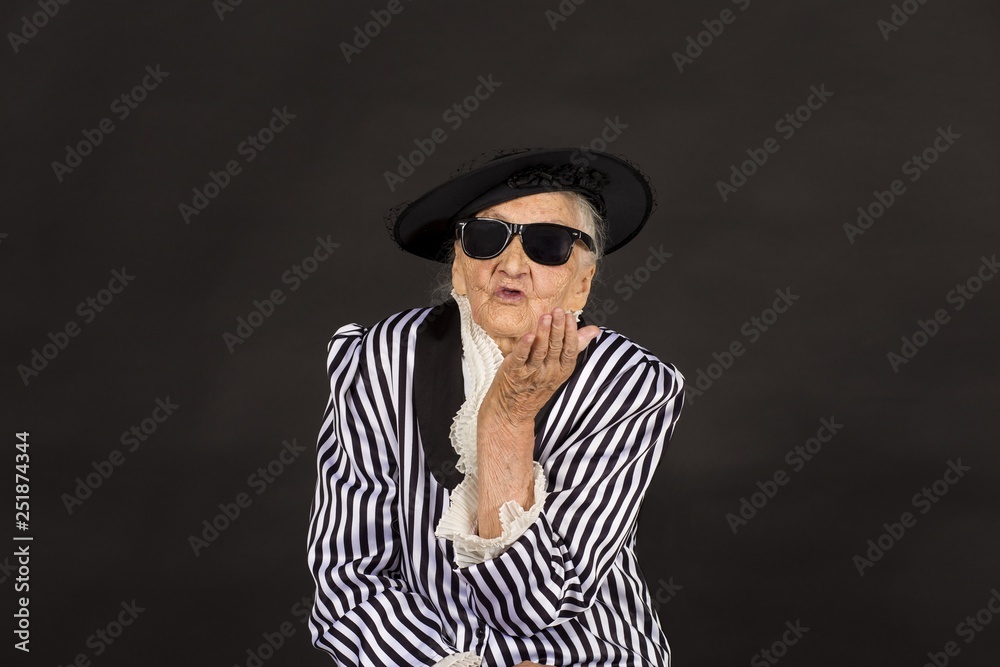 Old grandma in a white-black striped jacket Old grandma in a white-black striped jacket