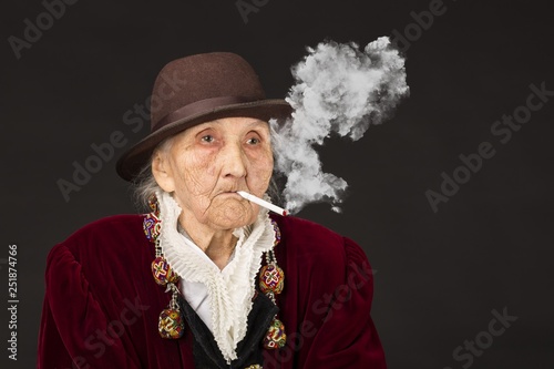 Old woman wearing a vermilion velvet jacket