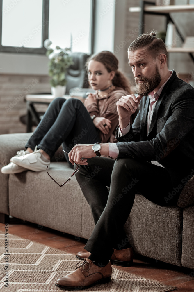 Father and daughter sitting on sofa after big nervous quarrel Father and daughter sitting on sofa after big nervous quarrel