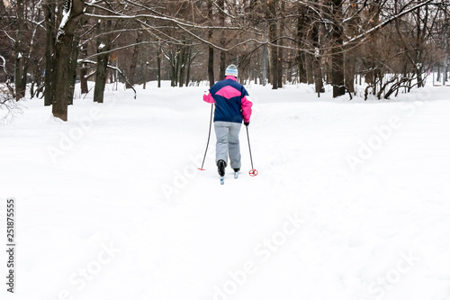 adult woman skiing in the park, active lifestyle