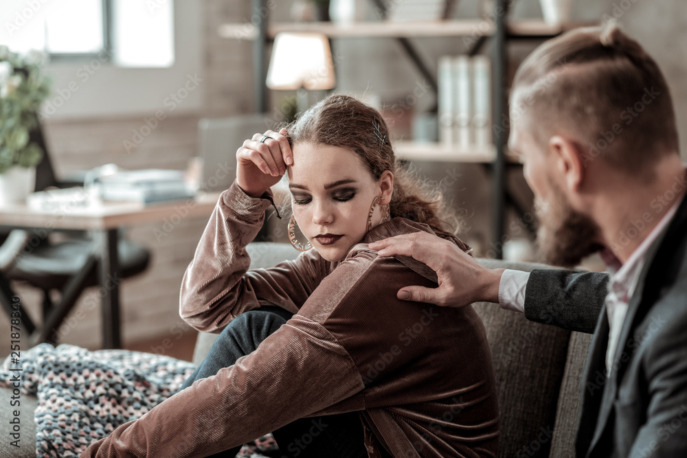Fototapeta premium Teenager with black eye shades feeling stressed after argument