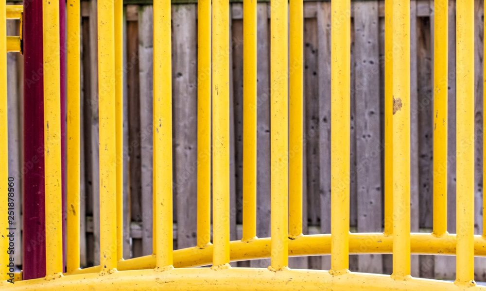 Playground Equipment in Front of a Fence