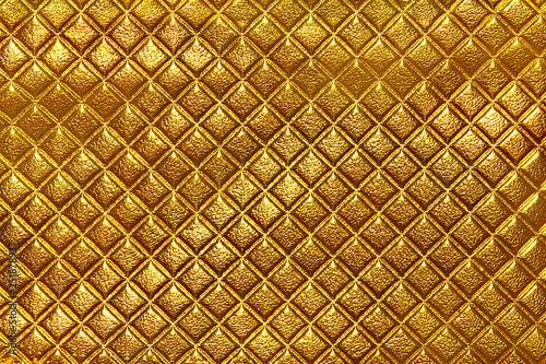 Abstract background texture of an old natural luxury, gold modern style leather with rhombs. photo