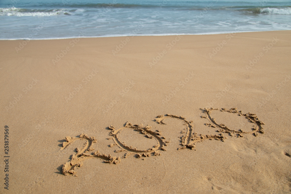 2020 Year written on the beach sand