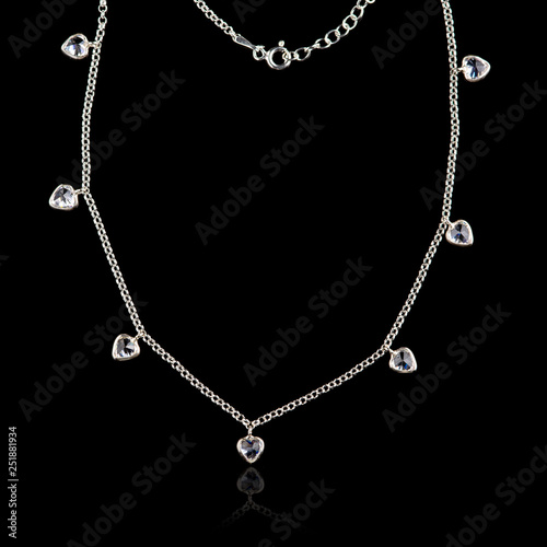 Silver necklace isolated on black background with reflection