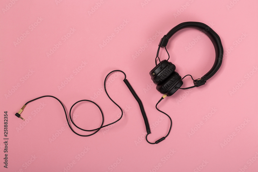 black headphones on pastel background. black headphones on pastel background.
