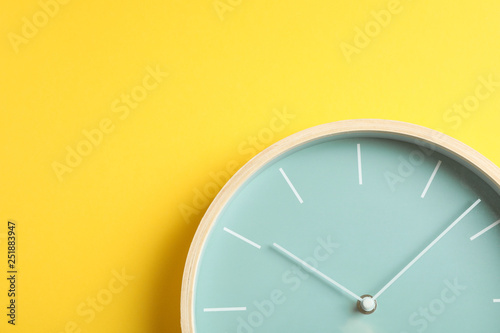 Big beautiful stylish clock on yellow background, space for text photo