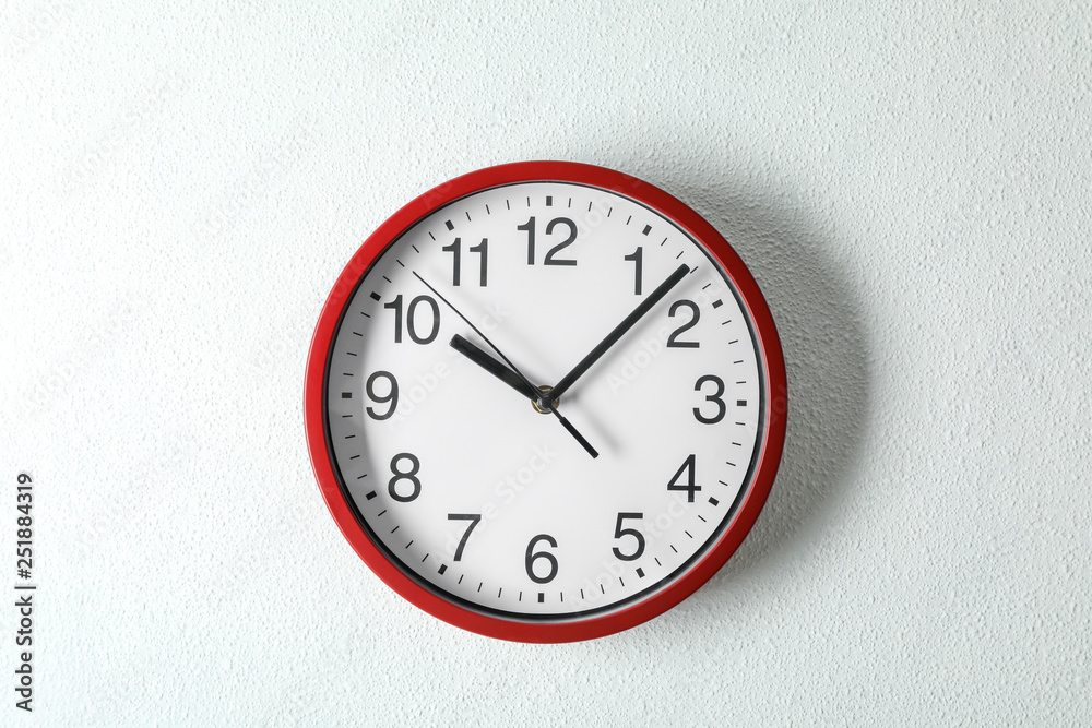 Big beautiful clock hanging on light background, space for text Big beautiful clock hanging on light background, space for text