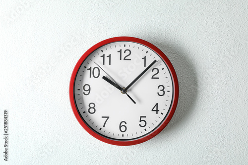 Big beautiful clock hanging on light background, space for text