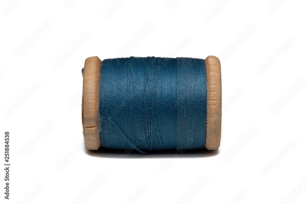 Wooden coil with thread on a white isolated background Wooden coil with thread on a white isolated background