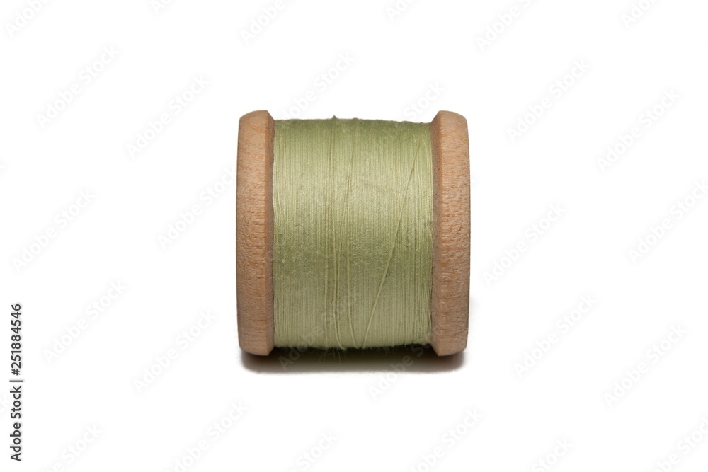 Wooden coil with thread on a white isolated background Wooden coil with thread on a white isolated background