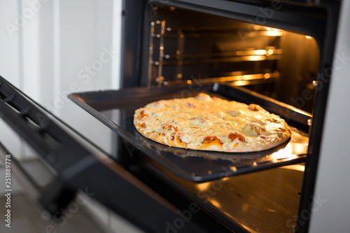 close up of tasty homemade pizza in hot oven