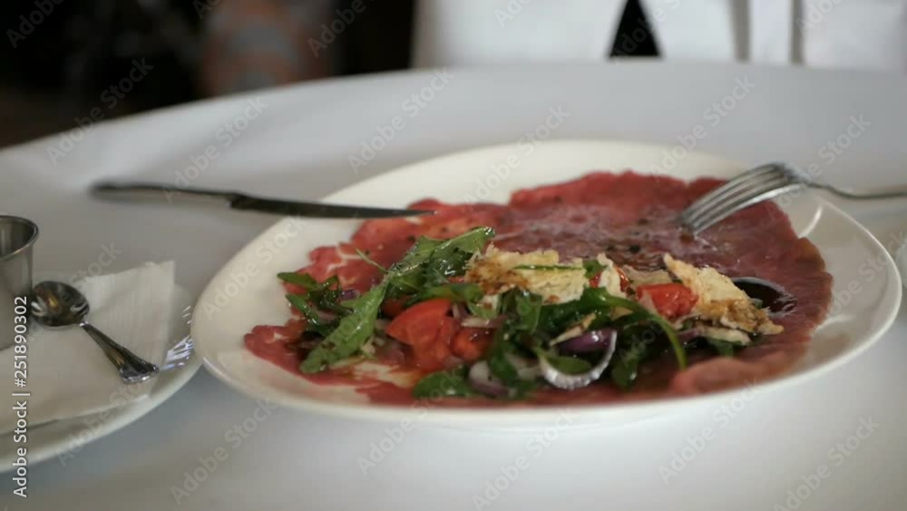 Beef carpaccio with arugula and parmesan cheese Beef carpaccio with arugula and parmesan cheese