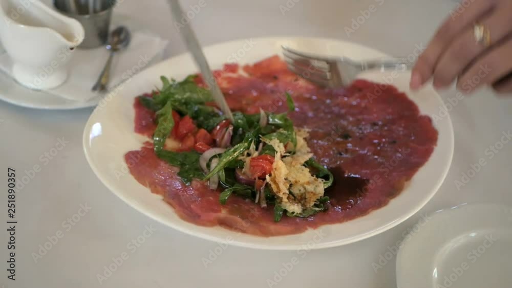 Beef carpaccio with arugula and parmesan cheese Beef carpaccio with arugula and parmesan cheese