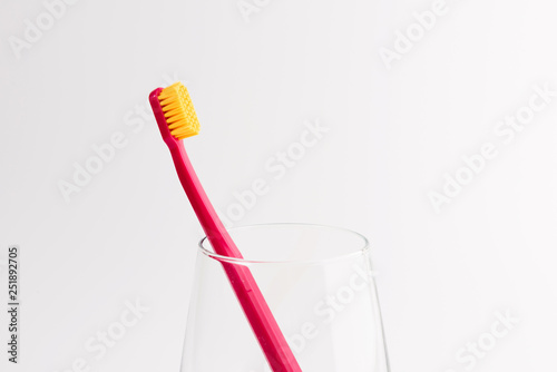 Cup with toothbrush isolated on white background. Dental care