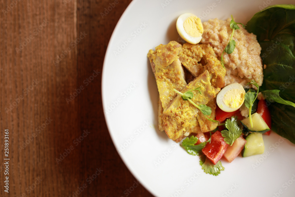 Chicken curry with salad in the plate, top view Chicken curry with salad in the plate, top view