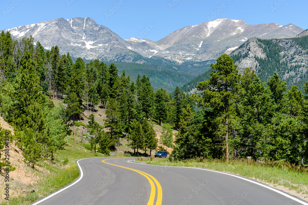 Summer Mountain Road - A summer view of winding Fall River Road (Highway 34), with Ypsilon Mountain and Fairchild Mountain of Mummy Range towering in background, Rocky Mountain National Park, CO, USA.