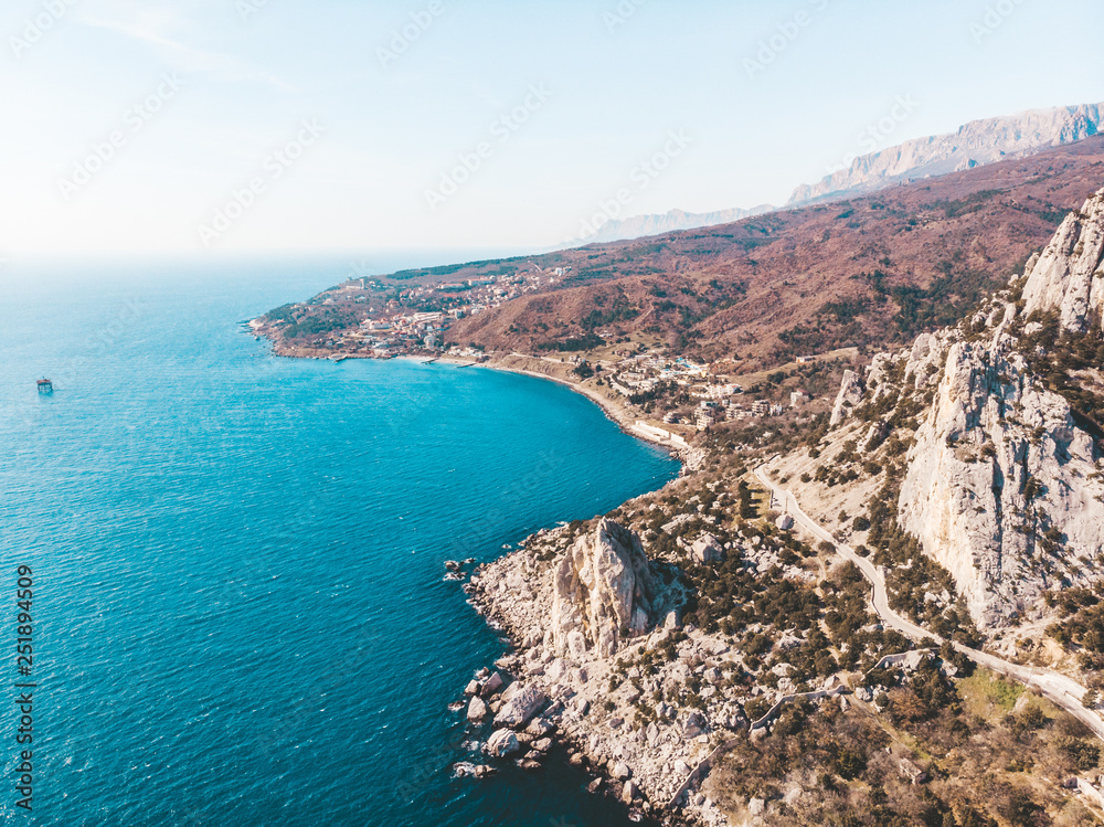 Aerial view from drone of beautiful mountain rocks and sea landscape in Simeiz, Crimea. Amazing tropical nature with coast, seascape and mountains Aerial view from drone of beautiful mountain rocks and sea landscape in Simeiz, Crimea. Amazing tropical nature with coast, seascape and mountains