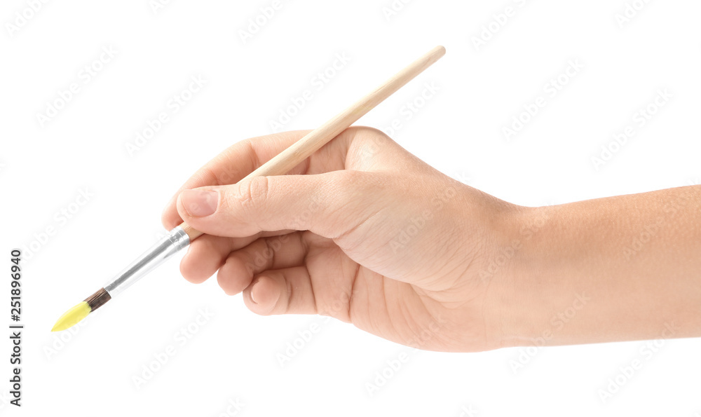 Young woman holding brush with color paint on white background, closeup