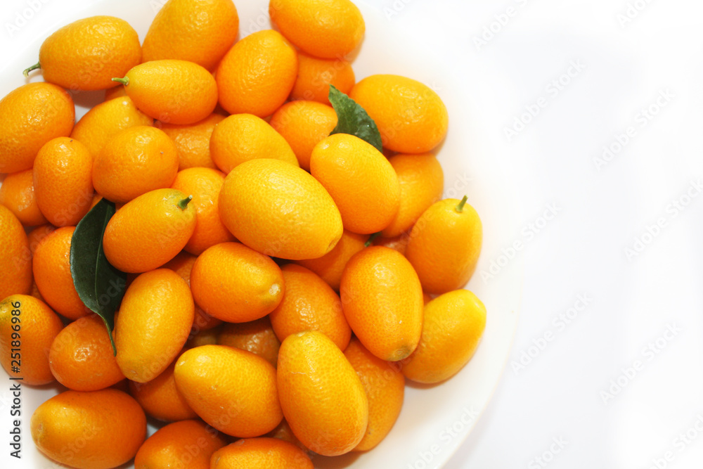 Small oranges on the white background. Nature fruits background.