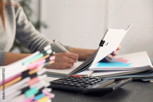 Office employee working with documents at table, closeup