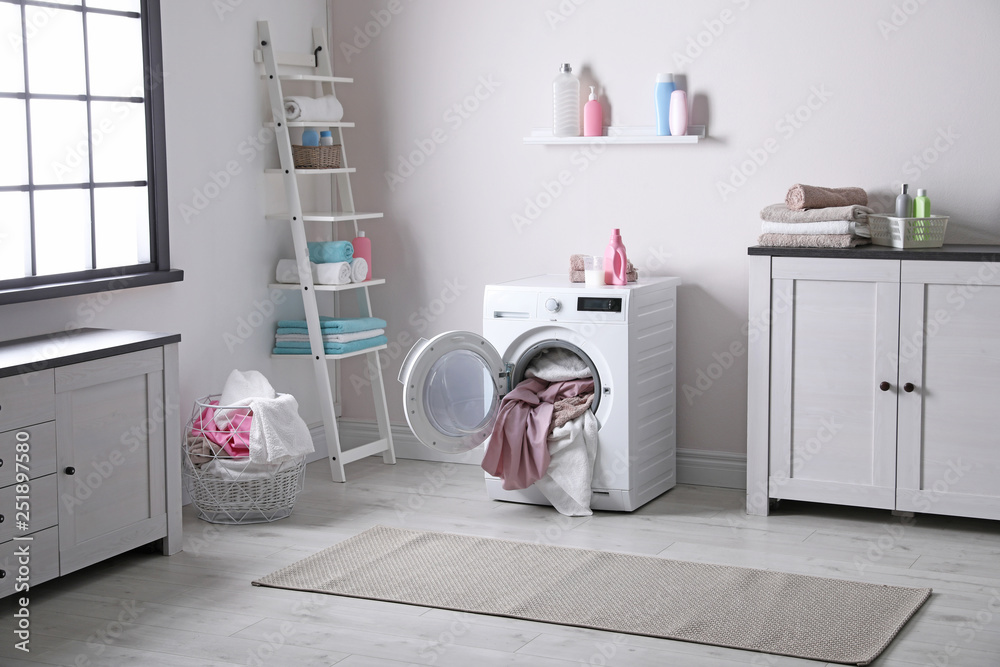 Bathroom interior with dirty towels in washing machine Bathroom interior with dirty towels in washing machine