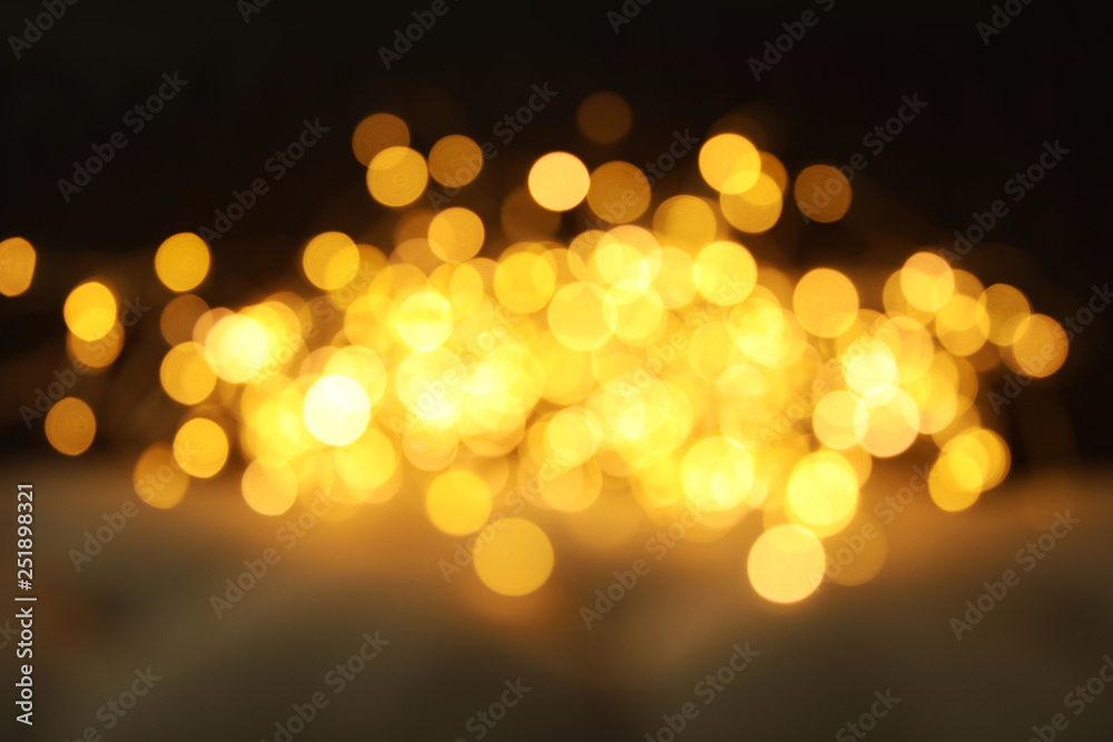 Gold glitter with bokeh effect on dark background Gold glitter with bokeh effect on dark background